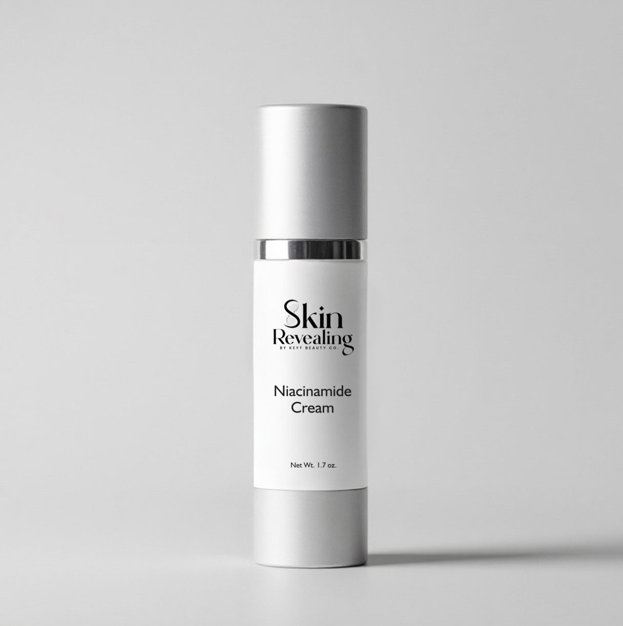 Skincare cream bottle labeled 'Skin Revealing Niacinamide Cream' on a gray background